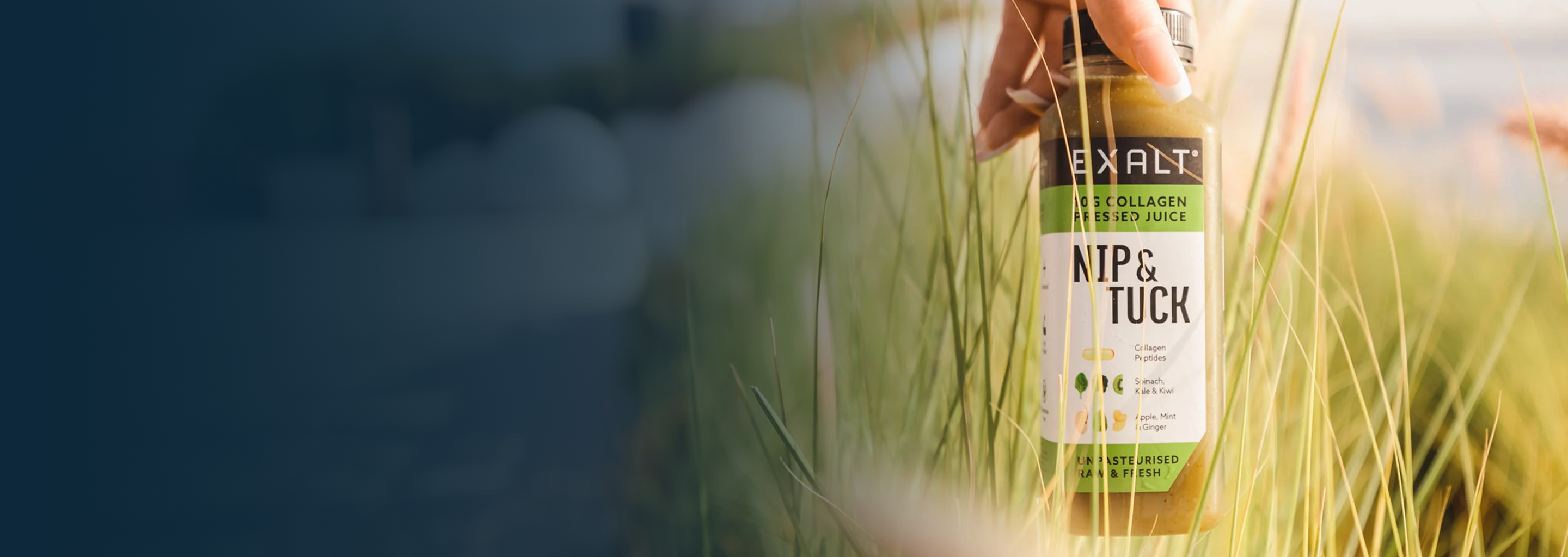 EXALT bottle held in long grass